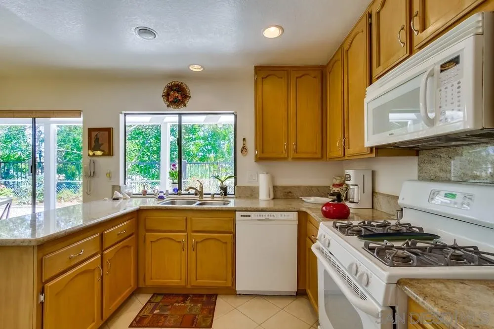 13354 Benchley Road San Diego, CA 92130 - Photo 10 of 24 a kitchen with a stove a sink and a microwave