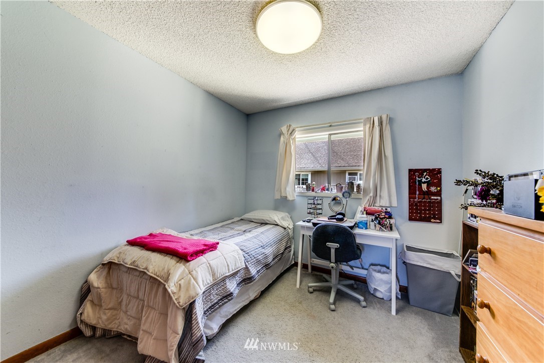 902 South Mullen Street Tacoma, WA 98405 - Photo 25 of 30 a bedroom with a bed and a chandelier