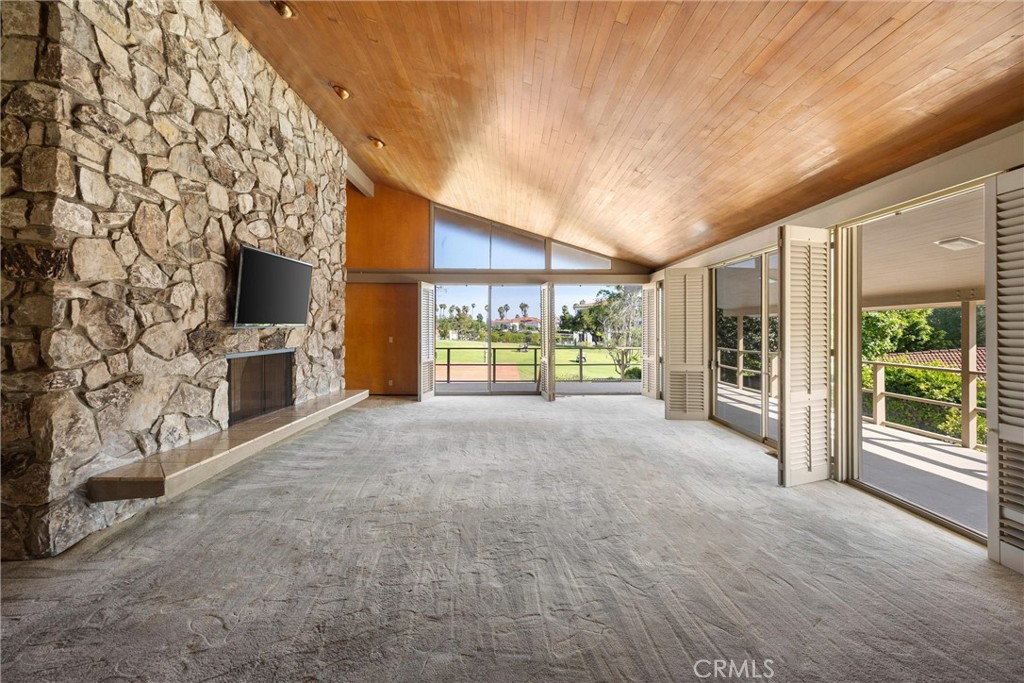 8780 Hillcrest Road Buena Park, CA 90621 - Photo 25 of 62 a view of an empty room with a fireplace and a window