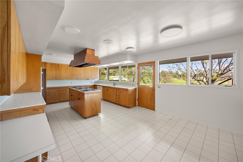8780 Hillcrest Road Buena Park, CA 90621 - Photo 34 of 62 a kitchen with stainless steel appliances kitchen island granite countertop a sink and a stove