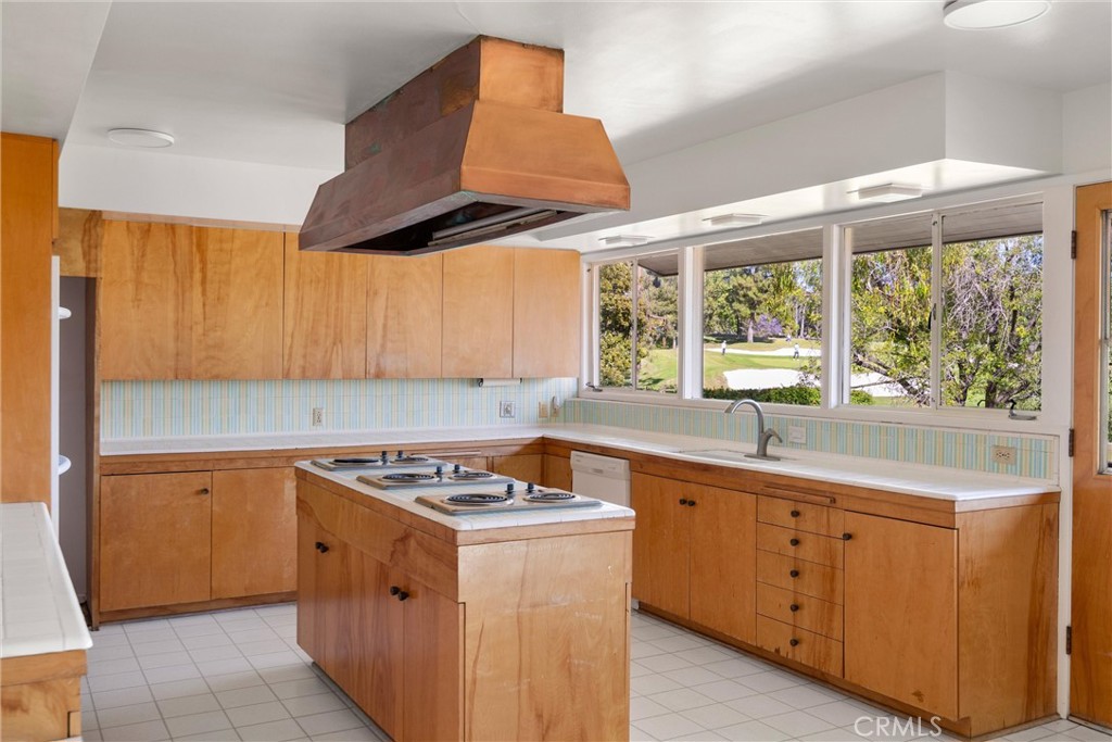 8780 Hillcrest Road Buena Park, CA 90621 - Photo 37 of 62 a kitchen with a sink a stove cabinets and a window