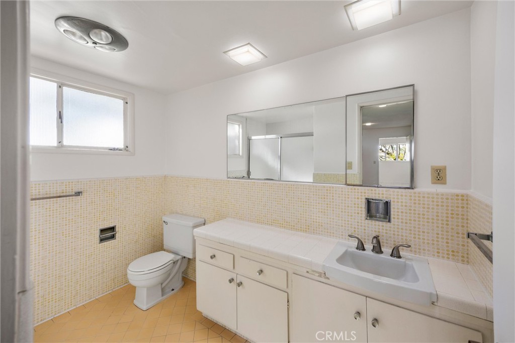8780 Hillcrest Road Buena Park, CA 90621 - Photo 41 of 62 a bathroom with a toilet sink and mirror
