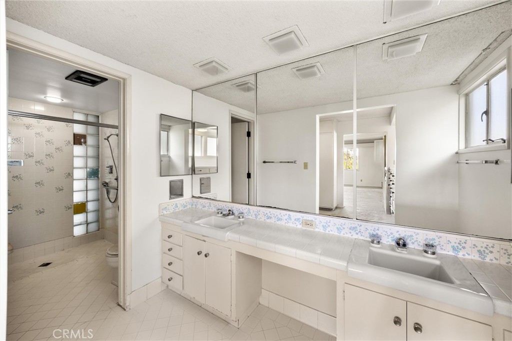 8780 Hillcrest Road Buena Park, CA 90621 - Photo 45 of 62 a bathroom with a granite countertop sink mirror and double