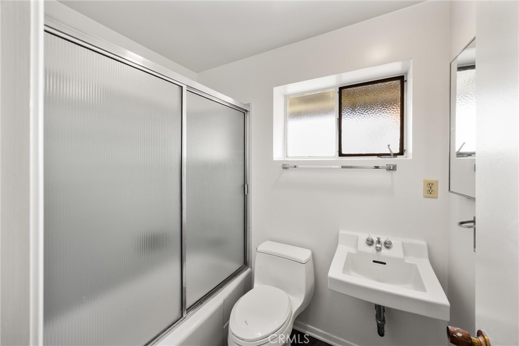 8780 Hillcrest Road Buena Park, CA 90621 - Photo 51 of 62 a white toilet sitting next to a bathroom sink