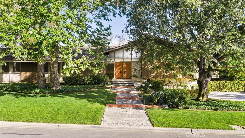 8780 Hillcrest Road Buena Park, CA 90621 - Photo 6 of 62 a front view of a house with garden