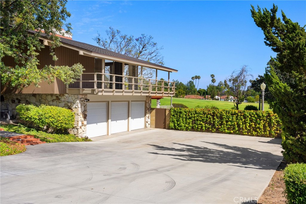 8780 Hillcrest Road Buena Park, CA 90621 - Photo 8 of 62 a front view of a house with a yard and potted plants