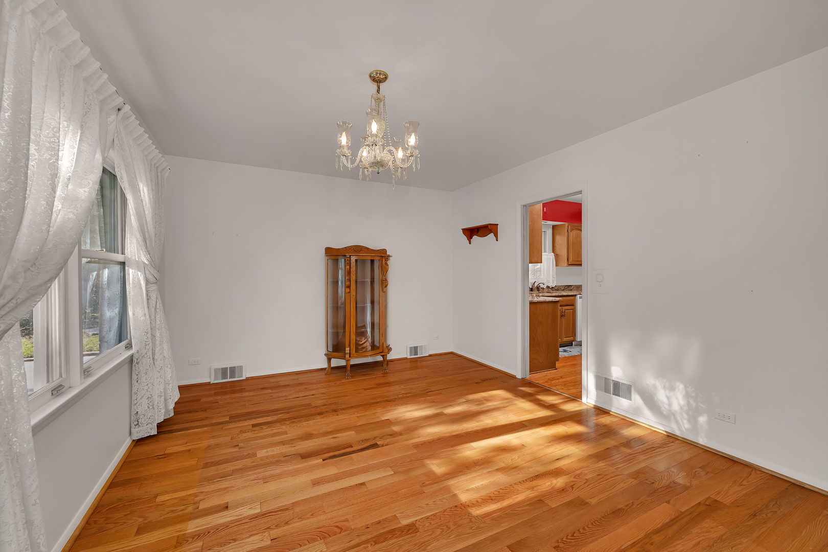 409 West Jefferson Street Morris, IL 60450 - Photo 11 of 44 a bedroom with a bed and a chandelier