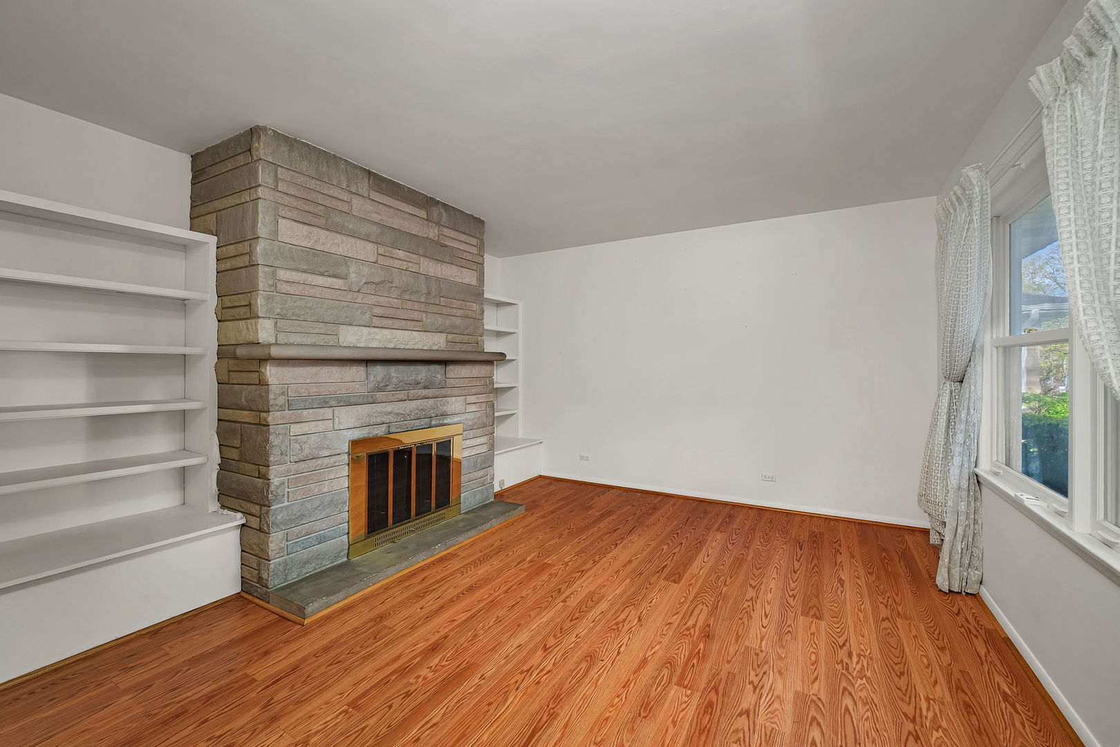 409 West Jefferson Street Morris, IL 60450 - Photo 12 of 44 a view of an empty room with wooden floor and a window