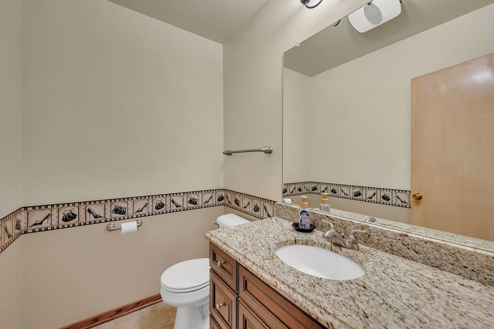 409 West Jefferson Street Morris, IL 60450 - Photo 15 of 44 a bathroom with a granite countertop sink a toilet and a mirror