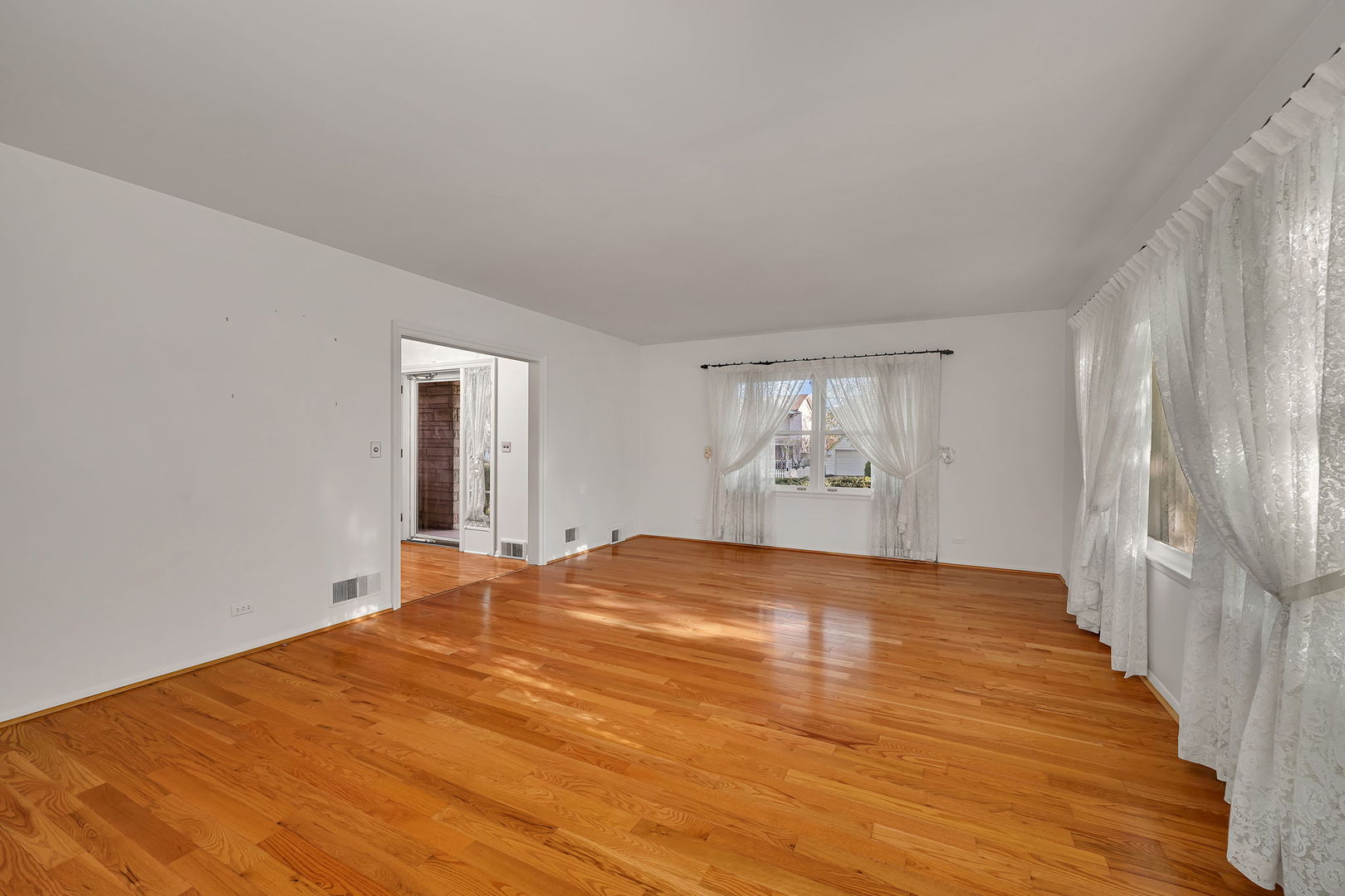 409 West Jefferson Street Morris, IL 60450 - Photo 10 of 44 a view of an empty room with window and wooden floor