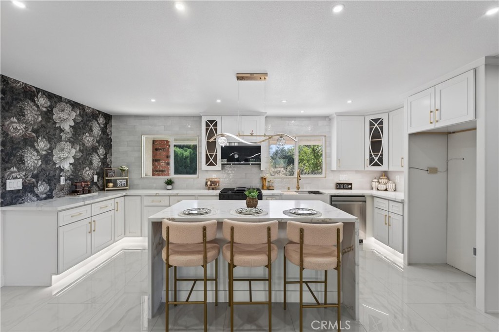 11891 San Timoteo Canyon Road Redlands, CA 92373 - Photo 18 of 68 a kitchen with stainless steel appliances kitchen island granite countertop a table chairs microwave and cabinets