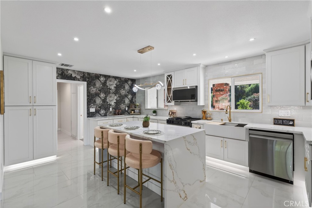 11891 San Timoteo Canyon Road Redlands, CA 92373 - Photo 19 of 68 a kitchen with white cabinets and stainless steel appliances