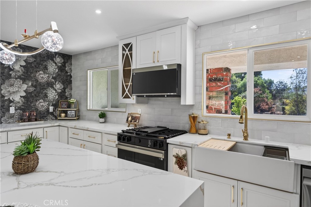 11891 San Timoteo Canyon Road Redlands, CA 92373 - Photo 22 of 68 a kitchen with a stove a sink and a microwave