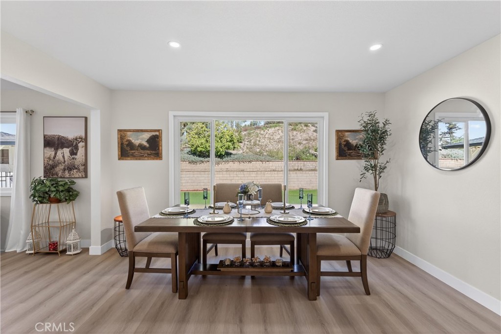 11891 San Timoteo Canyon Road Redlands, CA 92373 - Photo 31 of 68 a dining room with furniture a window and wooden floor