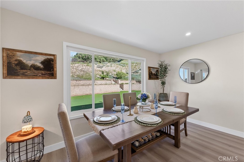 11891 San Timoteo Canyon Road Redlands, CA 92373 - Photo 32 of 68 a view of a dining room with furniture a large window and wooden floor