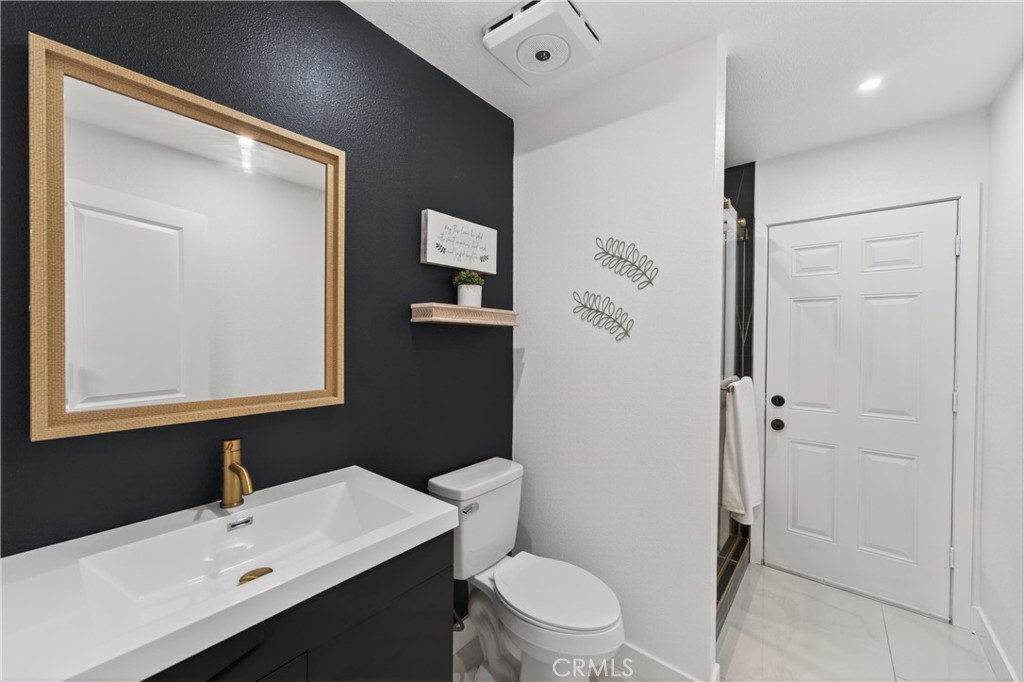 11891 San Timoteo Canyon Road Redlands, CA 92373 - Photo 35 of 68 a bathroom with a sink a toilet and shower