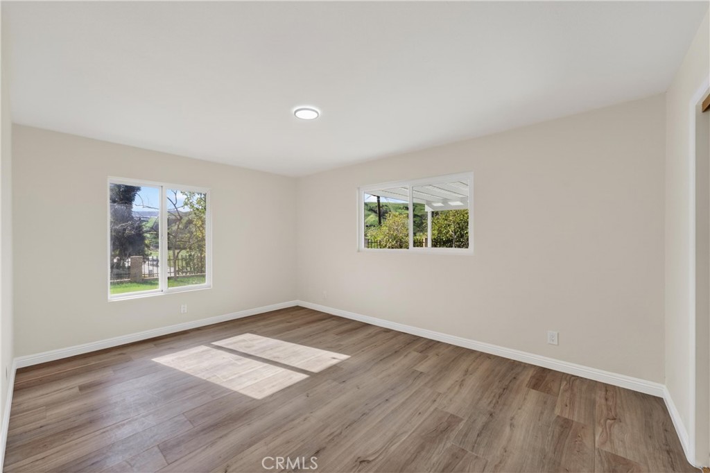 11891 San Timoteo Canyon Road Redlands, CA 92373 - Photo 37 of 68 an empty room with wooden floor and windows