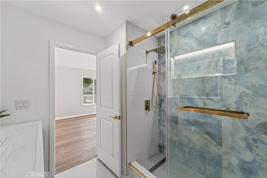 11891 San Timoteo Canyon Road Redlands, CA 92373 - Photo 39 of 68 a bathroom with a glass shower door