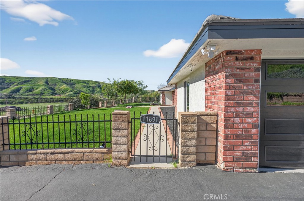 11891 San Timoteo Canyon Road Redlands, CA 92373 - Photo 9 of 68 a front view of a house with a garden