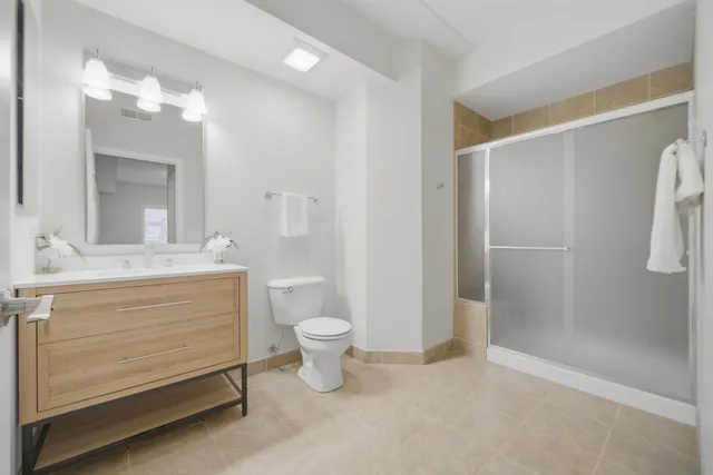 a bathroom with a sink a toilet and shower