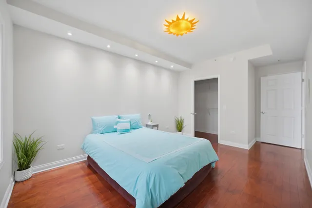 a bedroom with a bed and a potted plant