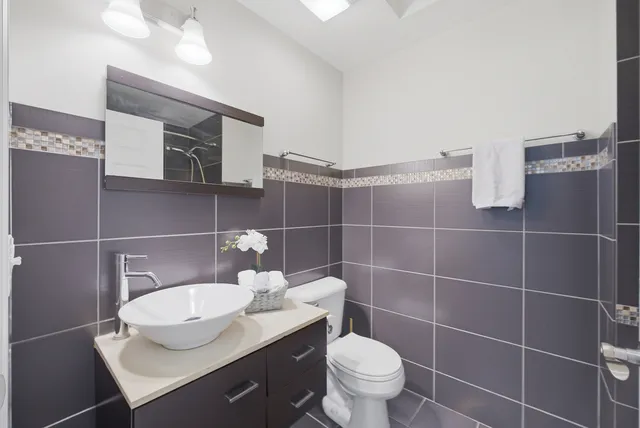 a bathroom with a sink toilet and a mirror