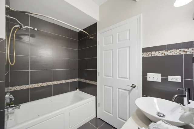 a white bath tub sitting next to a white sink