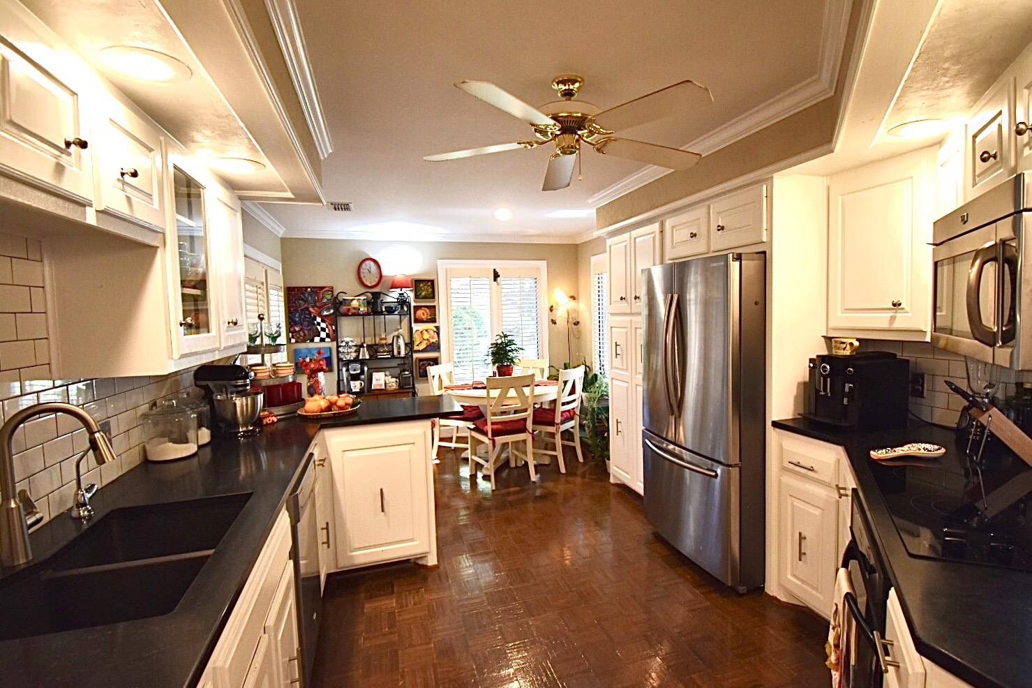 8201 Durham Avenue Lubbock, TX 79424 - Photo 16 of 33 a view of a kitchen with fridge and workspace