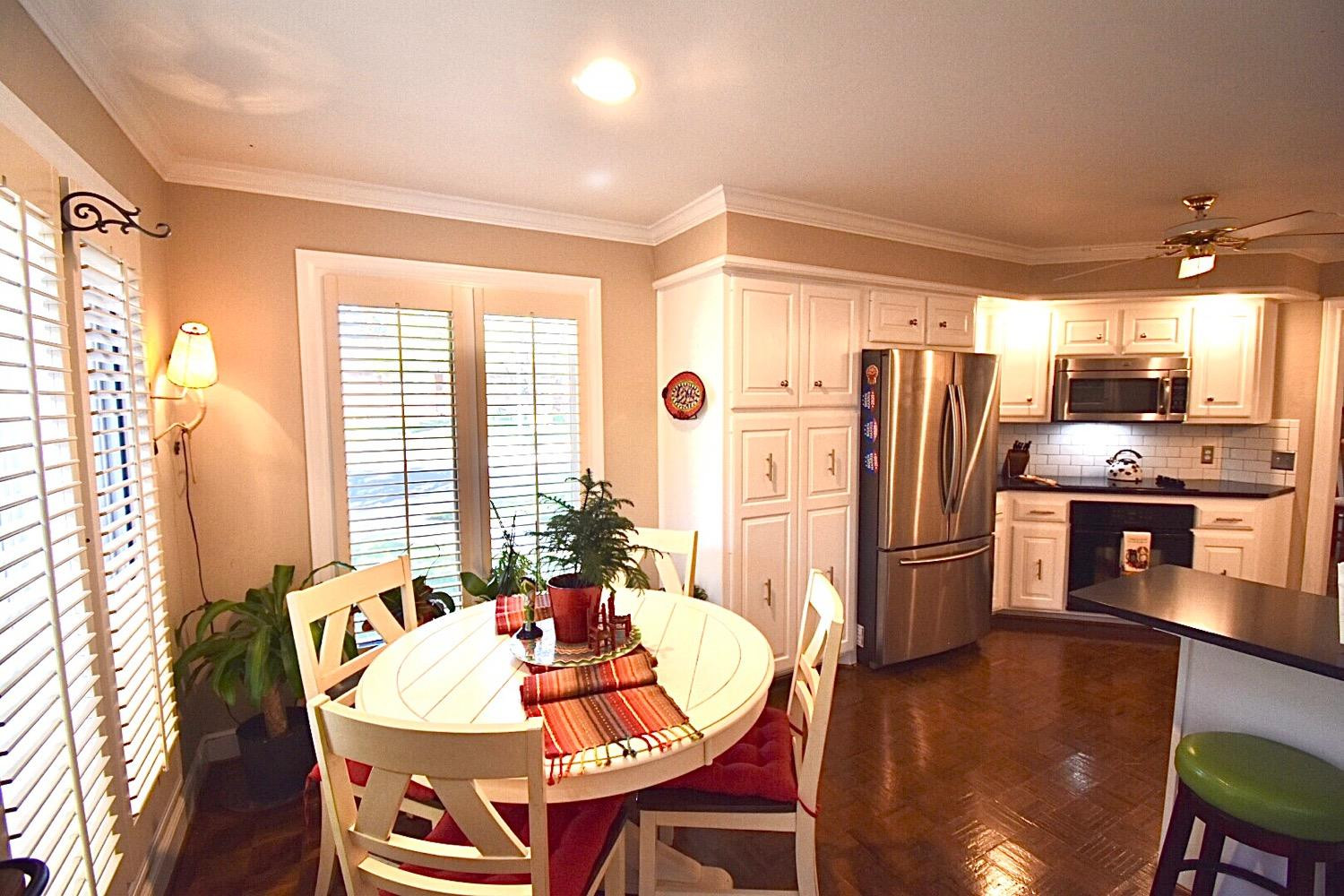 8201 Durham Avenue Lubbock, TX 79424 - Photo 18 of 33 a dining room with stainless steel appliances a dining table and chairs