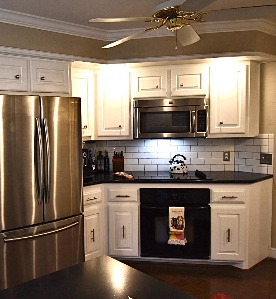 8201 Durham Avenue Lubbock, TX 79424 - Photo 19 of 33 a kitchen with granite countertop a refrigerator stove and microwave