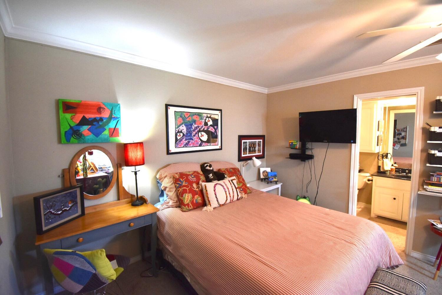 8201 Durham Avenue Lubbock, TX 79424 - Photo 21 of 33 a bedroom with a bed and a flat screen tv