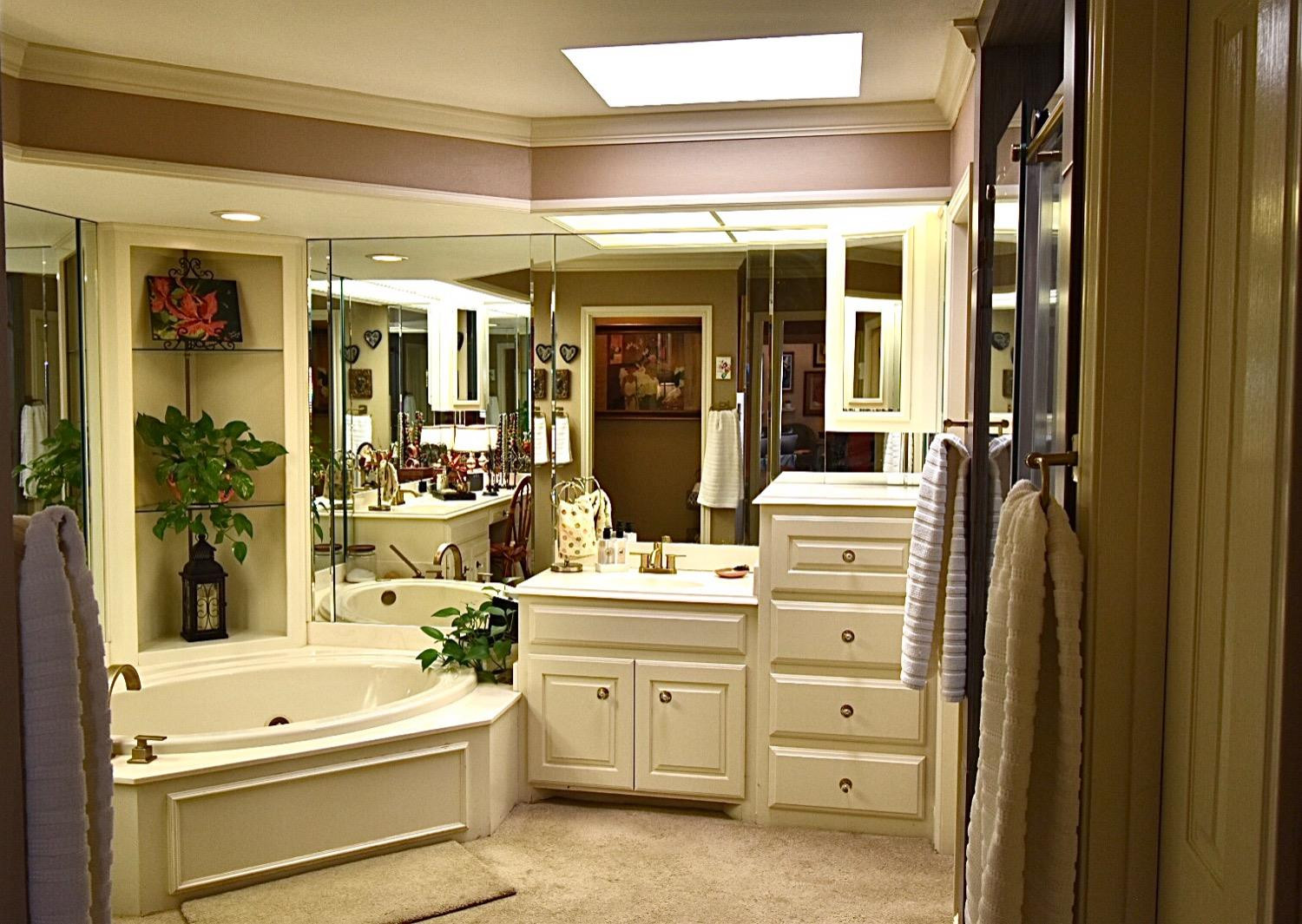 8201 Durham Avenue Lubbock, TX 79424 - Photo 28 of 33 a bathroom with a sink a large mirror and a bathtub