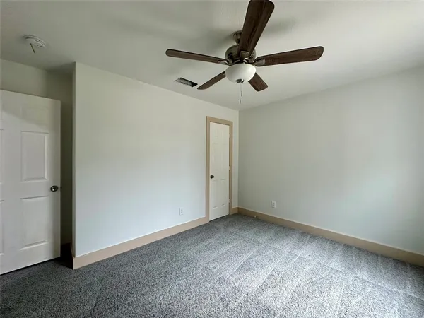 a view of room with a ceiling fan