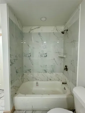 a bathroom with a bathtub and a shower