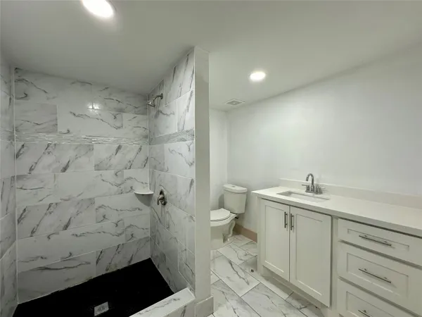 a bathroom with a sink toilet and shower