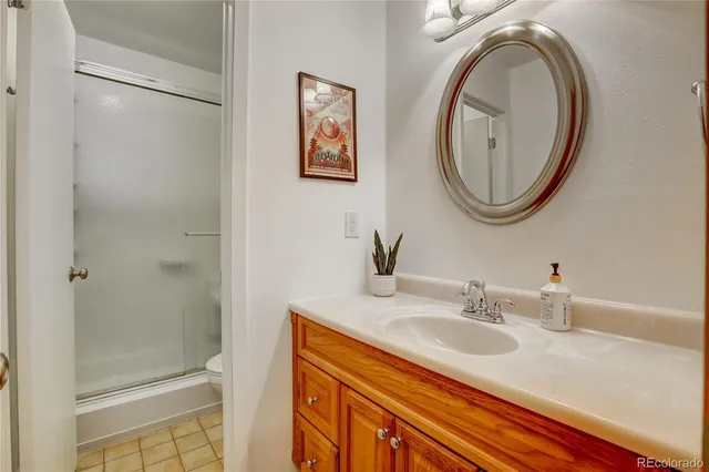 a spacious bedroom with a bed and a chandelier