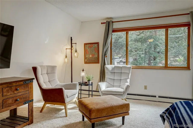 a spacious bedroom with a bed and a flat screen tv