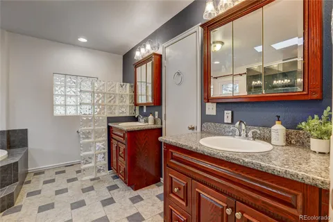 a bathroom with a tub a shower and a sink