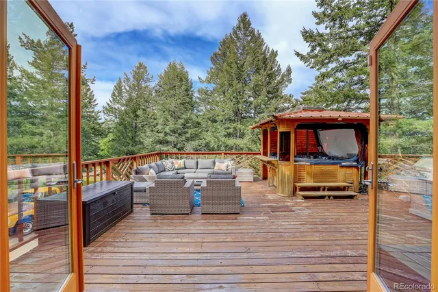 a rooftop view with patio couches coffee table and potted plants with sky view