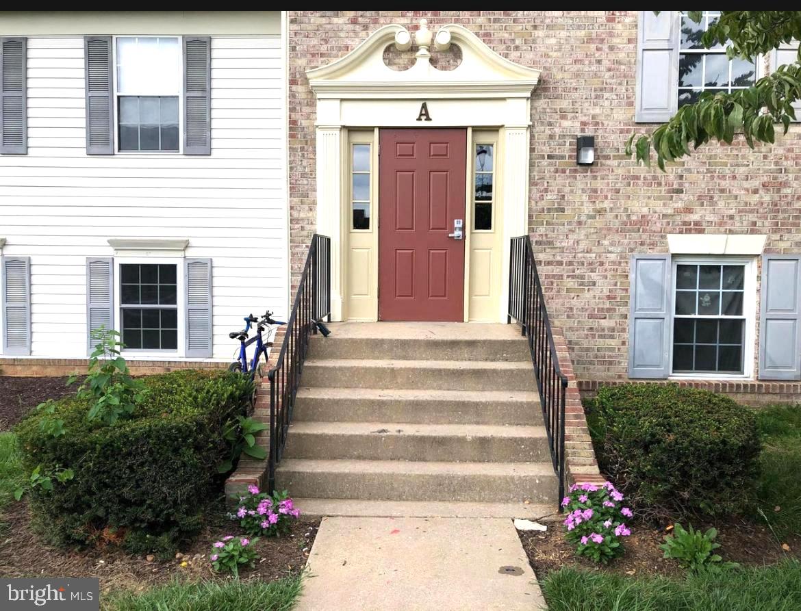 1405 Key Parkway, Unit 201A Frederick, MD 21702 - Photo 2 of 10 Charming entrance with vibrant blooms.