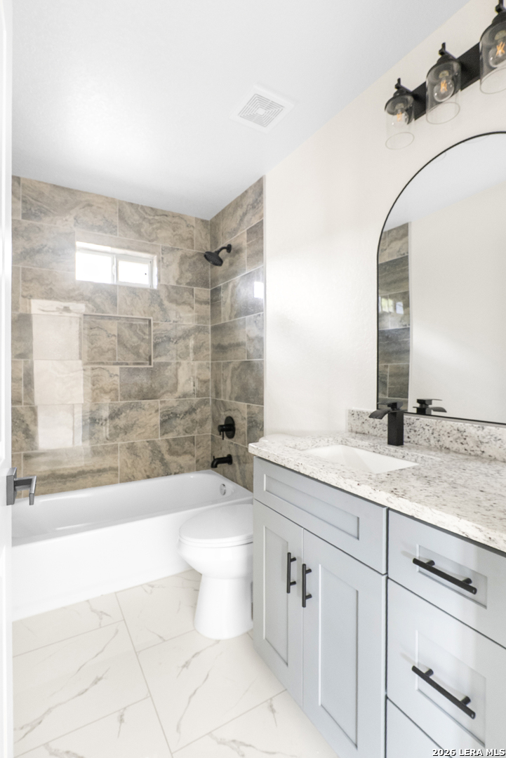 845 Tee Drive Spring Branch, TX 78070 - Photo 15 of 18 a bathroom with a granite countertop sink a toilet a mirror and bathtub