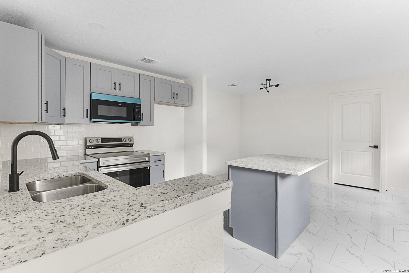 845 Tee Drive Spring Branch, TX 78070 - Photo 7 of 18 a kitchen with stainless steel appliances a stove a sink a microwave and refrigerator