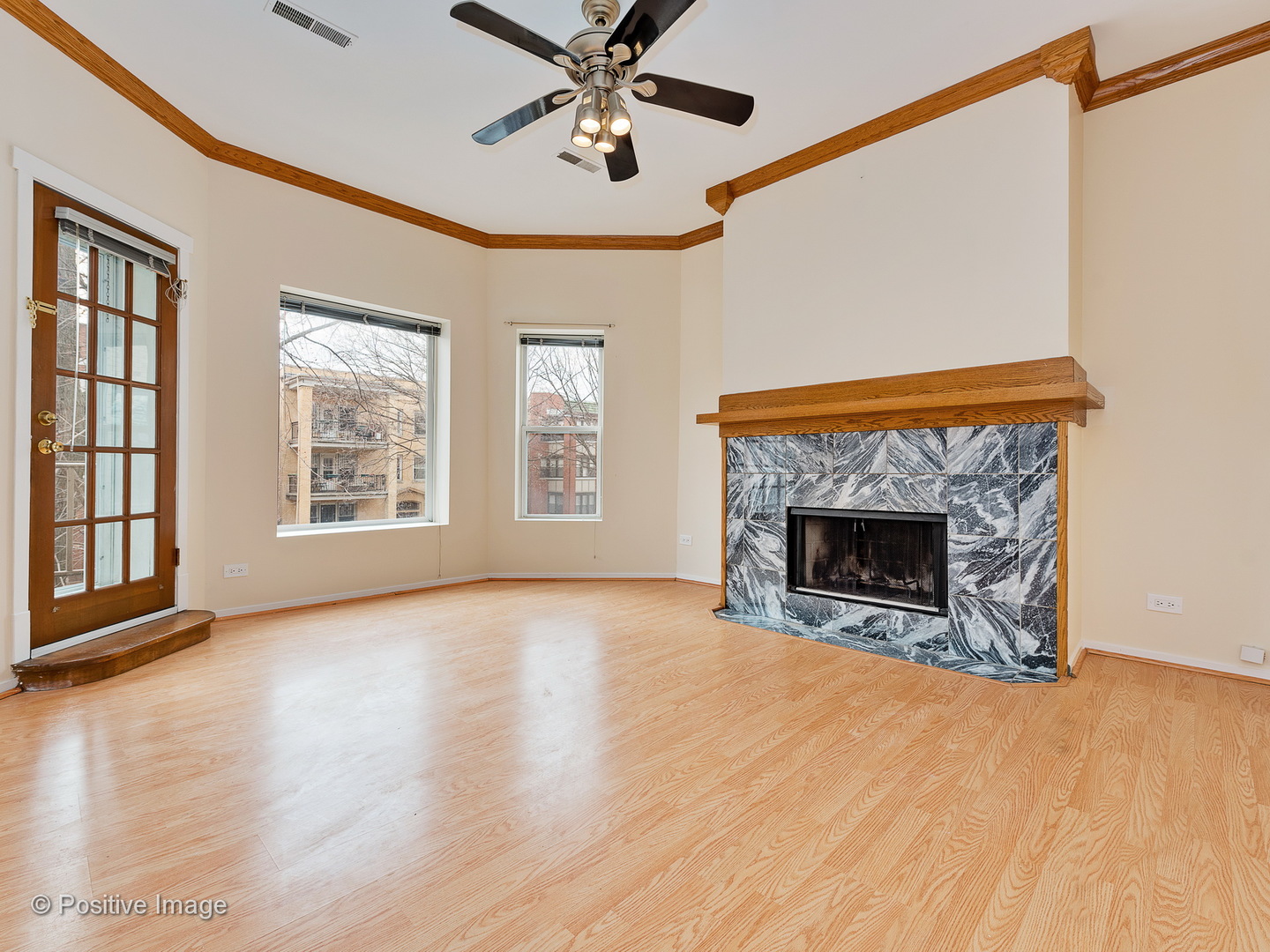 4417 North Racine Avenue, Unit 2N Chicago, IL 60640 - Photo 2 of 22 a view of an empty room with exposed radiator and fireplace