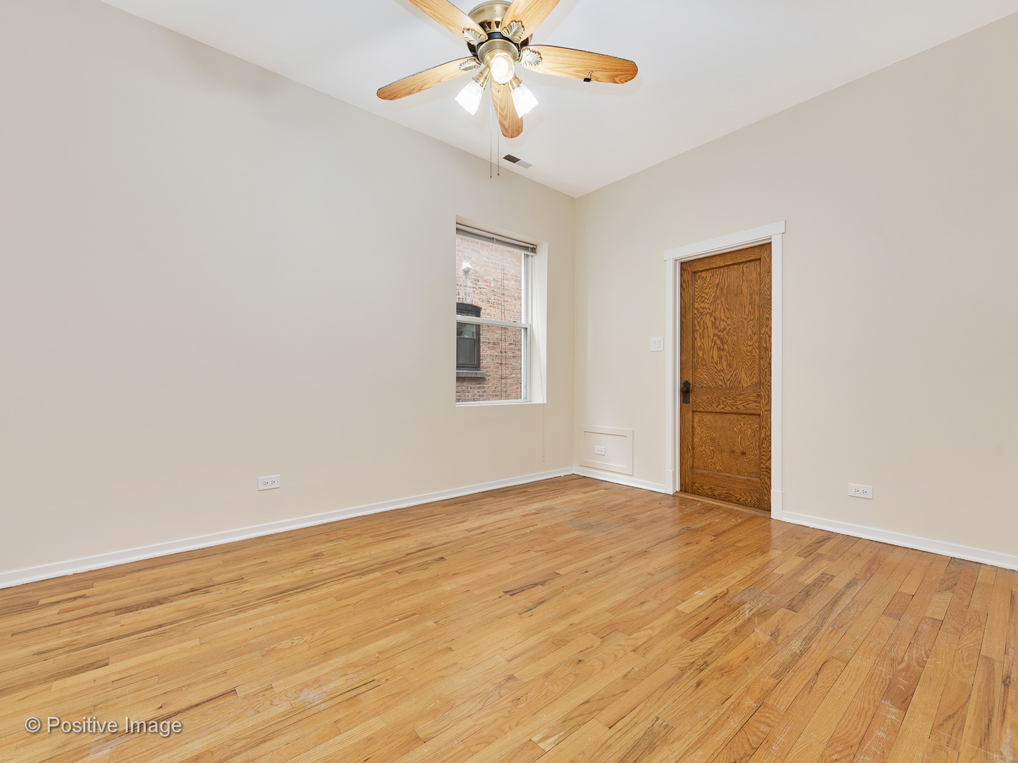 4417 North Racine Avenue, Unit 2N Chicago, IL 60640 - Photo 19 of 22 a view of an empty room with chandelier fan and a window