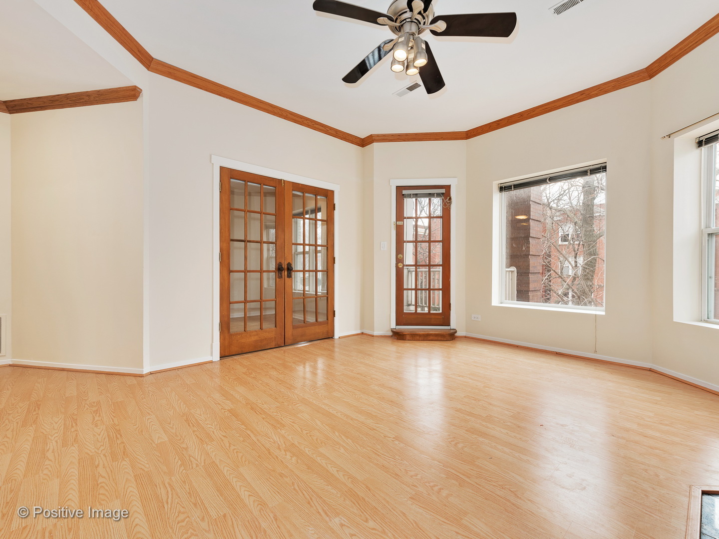 4417 North Racine Avenue, Unit 2N Chicago, IL 60640 - Photo 3 of 22 a view of an empty room with a window and wooden floor