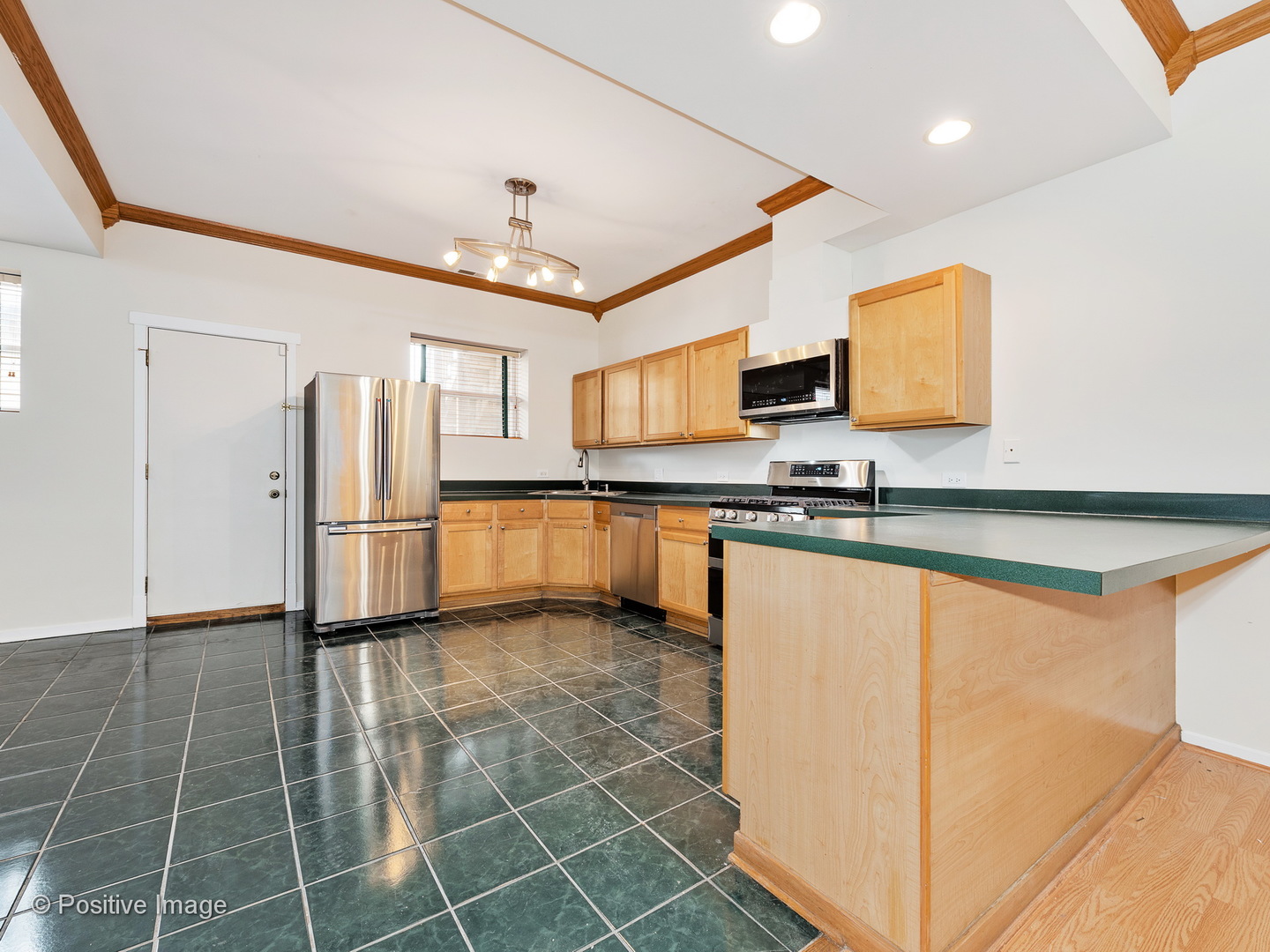 4417 North Racine Avenue, Unit 2N Chicago, IL 60640 - Photo 9 of 22 a kitchen with granite countertop a refrigerator and a stove top oven