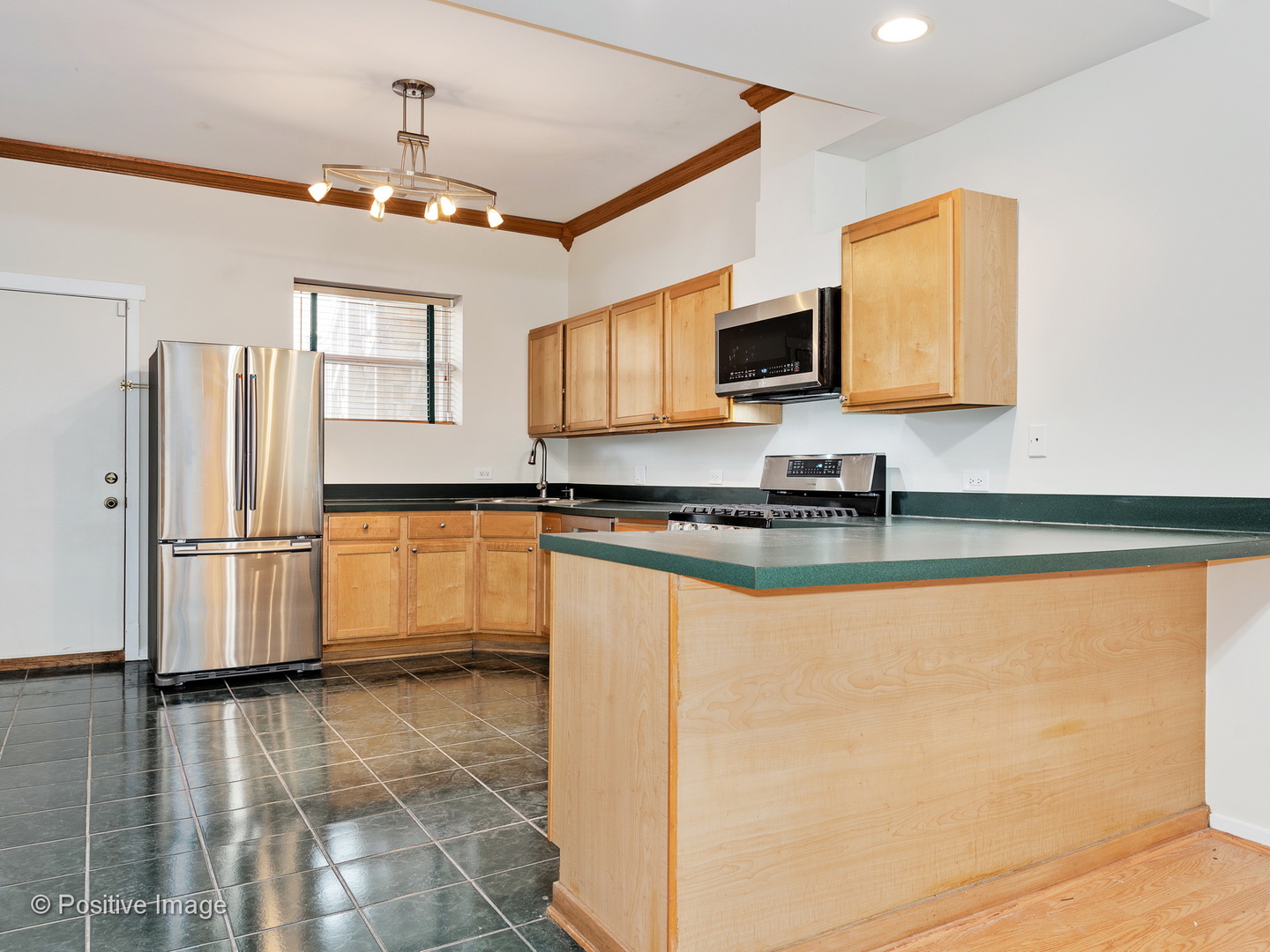 4417 North Racine Avenue, Unit 2N Chicago, IL 60640 - Photo 10 of 22 a kitchen with granite countertop a refrigerator and a stove top oven