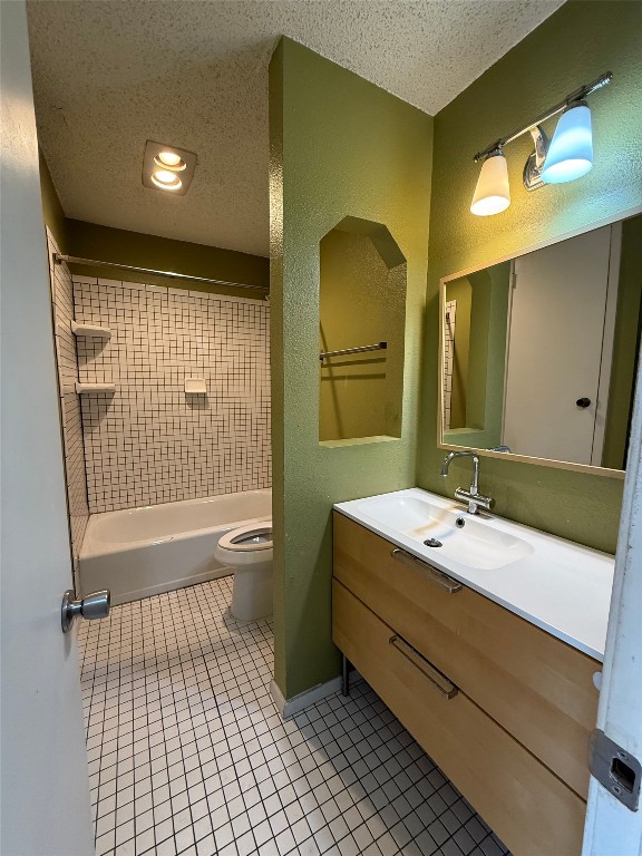 6200 Boxcar Run Austin, TX 78745 - Photo 6 of 7 Bathroom with vanity, a textured ceiling, shower / bath combination, and light tile patterned floors
