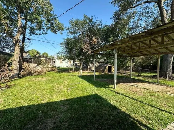 a view of swimming pool with a garden and trees