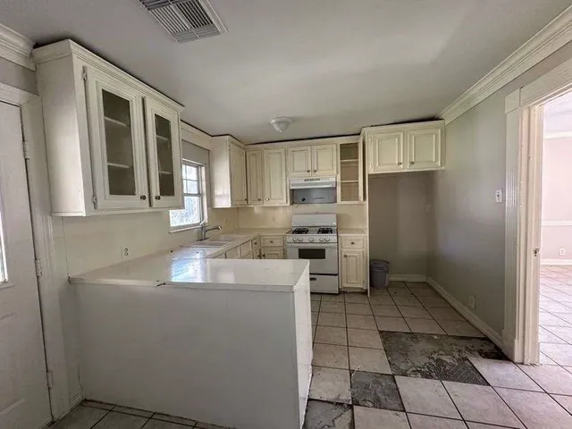 a kitchen with stainless steel appliances granite countertop a sink and a refrigerator